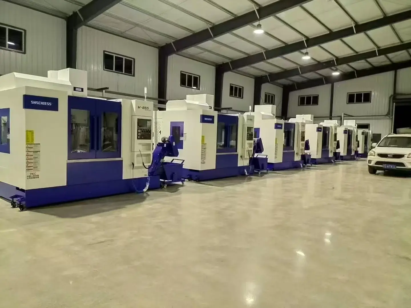 Row of V-855 machining centres in a workshop
